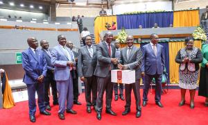 PSSF Chairman Hon Wycliffe Wangamati hands over a gift to the Treasury and Economic Planning Cabinet Secretary Hon John Mbadi during the 3rd AGM